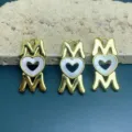 Detail shot of golden MOM letter and heart pendant, jewelry DIY accessory for custom necklaces. - Gold
