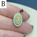 Close-up of oval mint green enamel Guadalupe pendant with gold rim for DIY jewelry. - Green