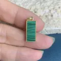 Detailed view of a rectangular green malachite patterned pendant with gold border for DIY jewelry. - Turquoise