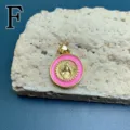 Detailed close-up view of gold plated pink enamel Virgin Mary pendant fashion item. - Style F