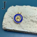 Close-up of a vintage blue enamel Mary pendant with gold-plated frame, detailed religious jewelry. - Style J
