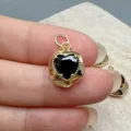 Close-up detail of a gold-plated irregular black heart zircon DIY pendant accessory. - Black