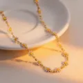 Gold-tone titanium steel chain necklace featuring enamel white and yellow daisy flower charms for women. - White Daisy Necklace Gold