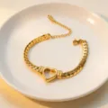 Exquisite gold heart hollow chain bracelet detail shot, elegant stainless steel link design. - Bracelet / Gold