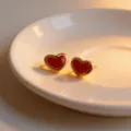 Charming red heart stud earrings with gold rim, elegant fashion jewelry detail view. - Red Heart Stud Earrings / 0.7