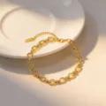 Gold chunky chain bracelet detail, interlocking oval links design with extension tail chain. - Bracelet / Gold
