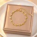Exquisite gold-plated titanium steel coffee bean chain bracelet detail, minimalist luxury style. - Bracelet / Gold