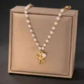 Pearl starfish necklace detail view, elegant beach vacation gold chain jewelry design. - Necklace