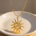 Gold spiral sun pendant necklace with snake chain, elegant fashion jewelry detail shot. - Necklace / Gold