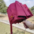 Wine red folding sun umbrella with UV protection, compact portable rain umbrella SKU. - Burgundy
