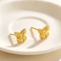 Detailed view of exquisite gold butterfly stud earrings, elegant metallic texture design. - Butterfly Studs
