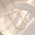 Minimalist stainless steel cross necklace with a single stone detail, elegant gold tone jewelry. - Necklace / Gold