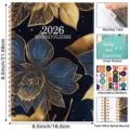 2026 monthly planner notebook with floral cover, twin-wire binding, tabs, and stickers. - English Planner Style D