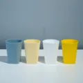 Colorful plastic cups set, modern minimalist tumblers in blue, yellow, white, and bright yellow. - Multi-color Cup Set