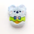 Close-up detail shot of the cute plush koala pendant, showing soft fabric and bow tie design. - Original (Open Back/No Brooch/No Chain) / Apron Koala