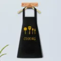 Black kitchen apron with cooking utensils print and front pocket, ideal for daily home cooking use. - Black Waterproof And Oil-Proof