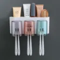 Wall mounted toothbrush holder set with three cups and toothpaste slot for bathroom organization - 3-Port