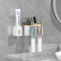 Wall-mounted toothbrush holder set with cups, toothpaste dispenser, and bathroom storage organizer. - Gold-Plated Toothbrush Holder [2 Slots + Dispenser]