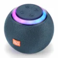 Close-up detail of spherical Bluetooth speaker showing mesh fabric texture and bright RGB light ring. - Blue