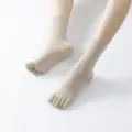 Comfortable beige five-toe yoga socks with non-slip grip dots, ideal for pilates and fitness. - One Size / Rice Apricot