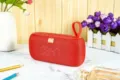 Tragbarer roter kabelloser Stoff Bluetooth-Lautsprecher mit Trageschlaufe und wasserdichtem Design. - Rot