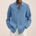 Close-up view of the blue long-sleeve linen button-up shirt showing fabric texture. - S / Light Blue