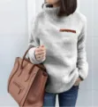 Close-up of cozy grey fleece high-neck pullover sweatshirt featuring a stylish front zipper. - S / Tops / Gray