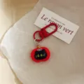 Close-up detail of cute cartoon apple black cat keychain bag pendant charm accessory. - Round Square Toe