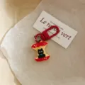 Cute black cat apple keychain enamel bag pendant cartoon metal charm student gift accessory - Sitting on Apple