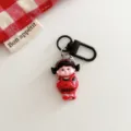 Detailed close-up view of dark cartoon girl keychain featuring black metal clasp and red accents. - Dark Girl - Overalls