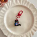 Cute black cat keychain with red metal clasp pendant, stylish bag accessory for backpack. - Little Black Cat Reading a Book