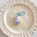 Cute surfing bear keychain detail shot, blue dress plush pendant for bags and school backpacks. - Charm / Blue Surfing Bear
