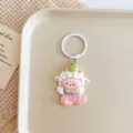 Close-up detail of a cute cartoon sheep keychain pendant with white ring and pink design. - Large Sheep / Pink Clothes