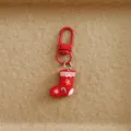 Close up detail of red Christmas stocking keychain with cute gingerbread man pattern, metal hook. - Christmas Sock
