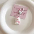Close-up detail of the cute white puppy keychain with pink bow and card packaging accessory. - Dog-Pink Scarf