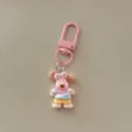 Cute cartoon puppy keychain with colorful outfit, perfect bag charm and keyring accessory. - Overall Pants Dog / Pink