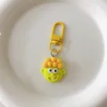 Close-up of a funny yellow cartoon character keychain, cute bag charm and accessory detail. - Yellow