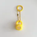 Yellow fitness kettlebell keychain detail showcasing cute bag charm and creative backpack accessory. - Yellow