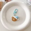 Cute cartoon sleeping bear keychain with light blue hook, stylish bag pendant accessory. - Blue Bear with Sleep Hat