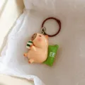 Cute cartoon capybara keychain pendant with coffee cup and green pillow for backpack bag charm. - Capybara Pillow Style