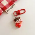 Adorable red cartoon doll keychain pendant for backpack decoration and festive New Year gift. - Fortune Doll with Couplets