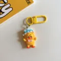 Cute cartoon yellow duck keychain pendant detail view, lovely resin bag charm accessory. - Top Hat Style