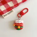 Cute Christmas keychain detail shot featuring a festive cartoon charm with red metal clasp. - Glove Style
