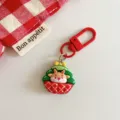 Close-up detail of a cute Christmas deer keychain pendant with red metal clasp and design. - Reindeer Flower Basket Style