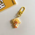 Close-up of cute cartoon yellow duck keychain pendant, adorable bag charm accessory gift. - Fish Head Style