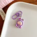 Detailed close-up of cute purple cartoon doll keychain, sweet backpack pendant accessory. - Purple