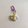 Detailed close-up of a cute cartoon pig dress-up keychain pendant with purple clasp. - One Piece / Purple