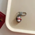 Close-up of a cute cartoon penguin keychain pendant with red scarf, ideal bag accessory. - Cartoon Penguin Pendant / Penguin