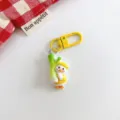 Cute cartoon duck keychain with leek pendant, yellow metal clasp, aesthetic bag hanging accessory decor. - Social Duck - Yellow