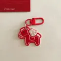 Red Dala horse keychain with money bag charm, cute cartoon bag pendant for New Year gift. - Red Pony